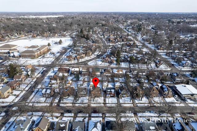 snowy aerial view featuring a residential view