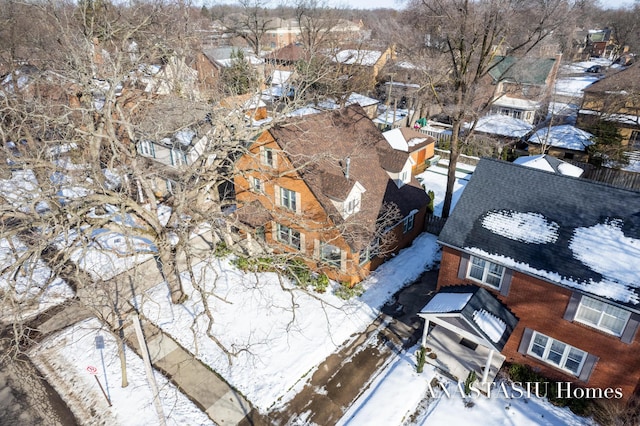 snowy aerial view featuring a residential view