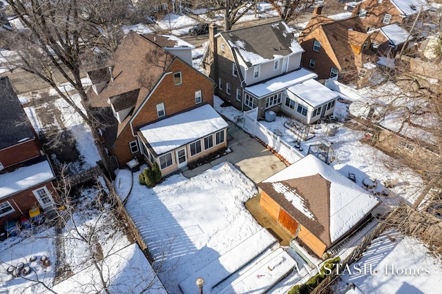 snowy aerial view with a residential view