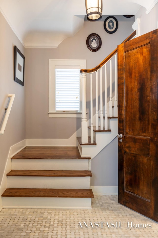 staircase featuring baseboards