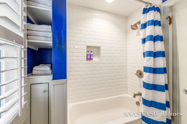 bathroom with shower / bath combo and wainscoting