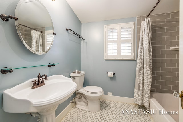 full bathroom with a sink, baseboards, toilet, and tile patterned flooring