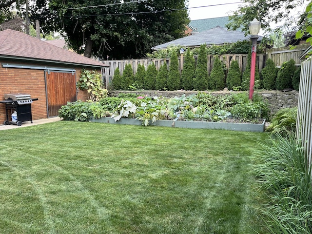 view of yard with fence and a garden