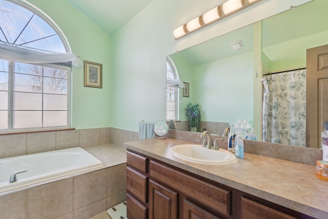 511 State St, Oxford, MI 48371 - bathroom with vaulted ceiling, vanity, and a garden tub