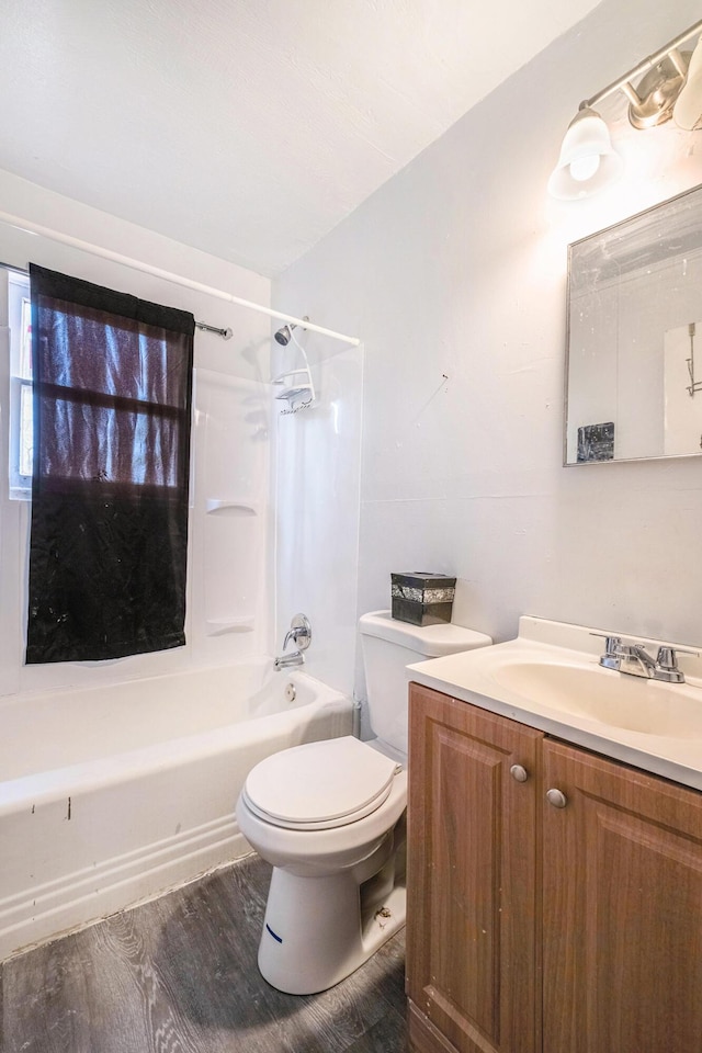 bathroom with toilet, vanity, bathing tub / shower combination, and wood finished floors