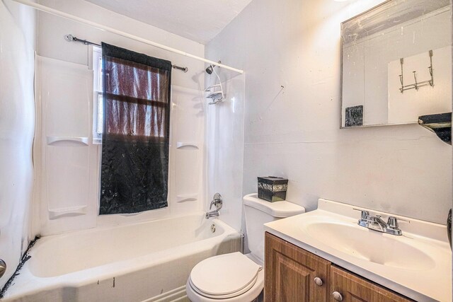 bathroom featuring vanity, toilet, and  shower combination