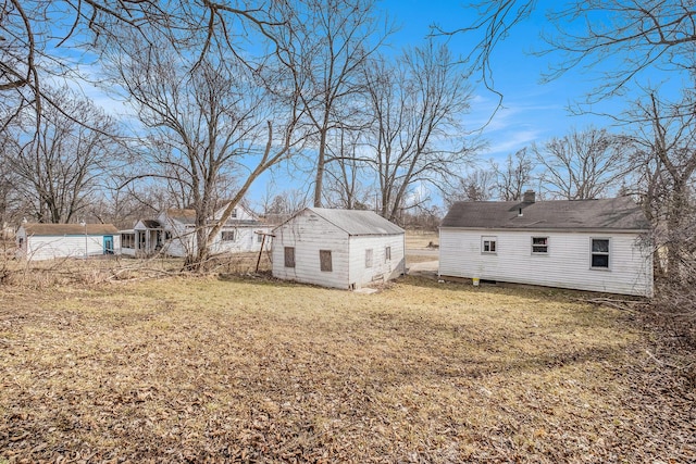 view of yard with a storage shed and an outbuilding