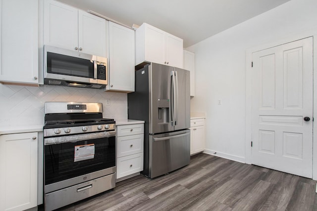 kitchen featuring backsplash, dark wood finished floors, white cabinetry, stainless steel appliances, and light countertops