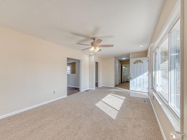 empty room with visible vents, ceiling fan, carpet, baseboards, and recessed lighting