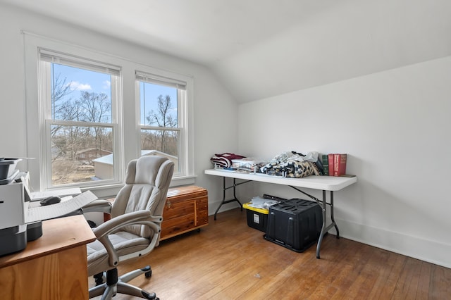 office space featuring hardwood / wood-style floors, vaulted ceiling, and baseboards