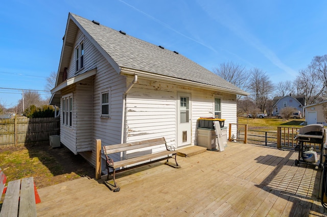 wooden terrace featuring grilling area and fence