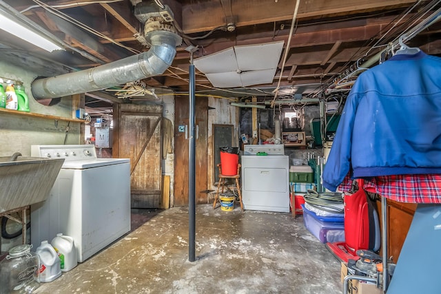 unfinished basement with independent washer and dryer and a sink