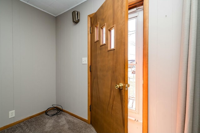 entryway with baseboards and carpet floors