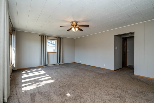 spare room with visible vents, baseboards, ceiling fan, and carpet flooring