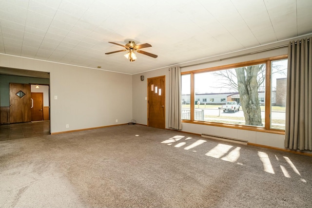 empty room featuring baseboards, carpet floors, and ceiling fan