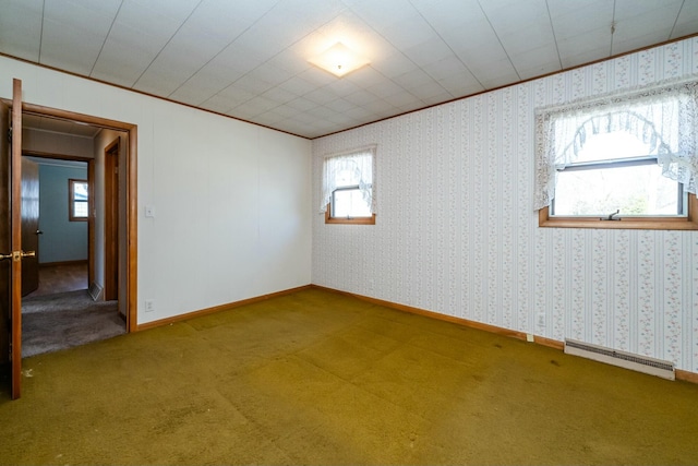 carpeted empty room featuring wallpapered walls, visible vents, and ornamental molding