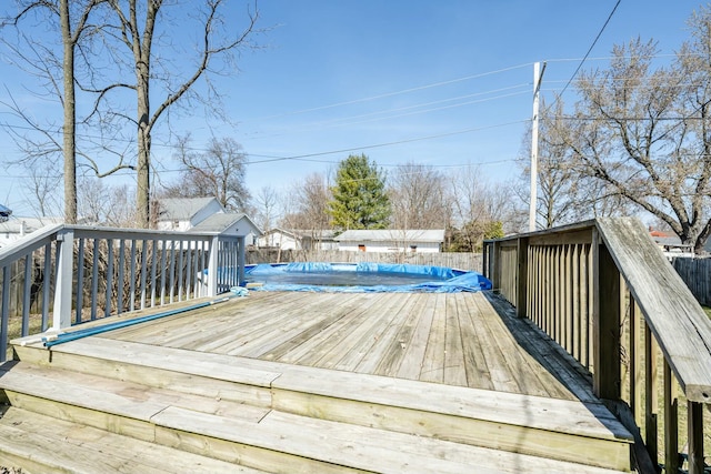 wooden terrace with a fenced in pool and a fenced backyard