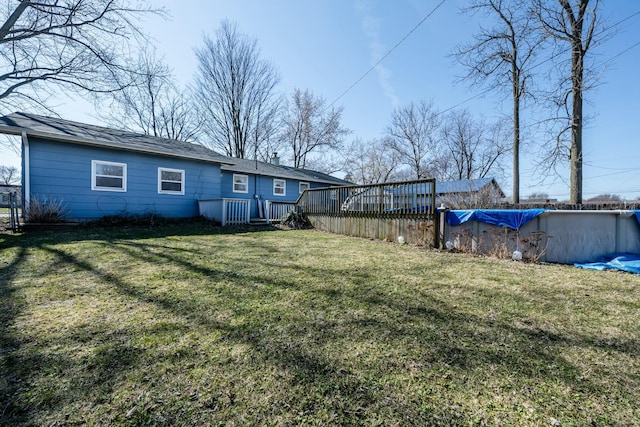 view of yard with a covered pool and a wooden deck