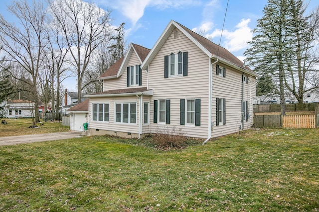 rear view of house with crawl space, a yard, a garage, and fence