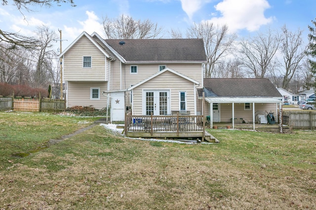 rear view of house with a yard, french doors, fence, and roof with shingles