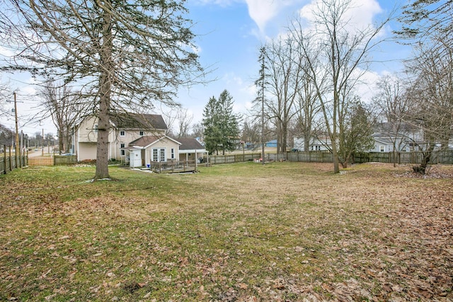 view of yard with a deck and a fenced backyard