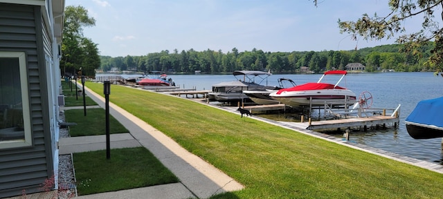 9059 Clam Lake Rd, Bellaire, MI 49615 - dock area featuring boat lift, a forest view, a yard, and a water view