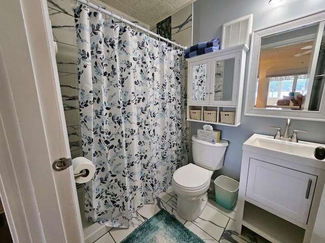 9059 Clam Lake Rd, Bellaire, MI 49615 - full bath featuring a shower with shower curtain, marble finish floor, toilet, and vanity