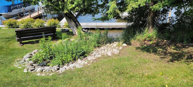 9059 Clam Lake Rd, Bellaire, MI 49615 - view of yard with a water view and a dock