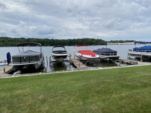9059 Clam Lake Rd, Bellaire, MI 49615 - dock area with boat lift, a lawn, and a water view