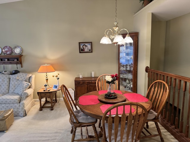 dining room featuring baseboards, light carpet, and an inviting chandelier