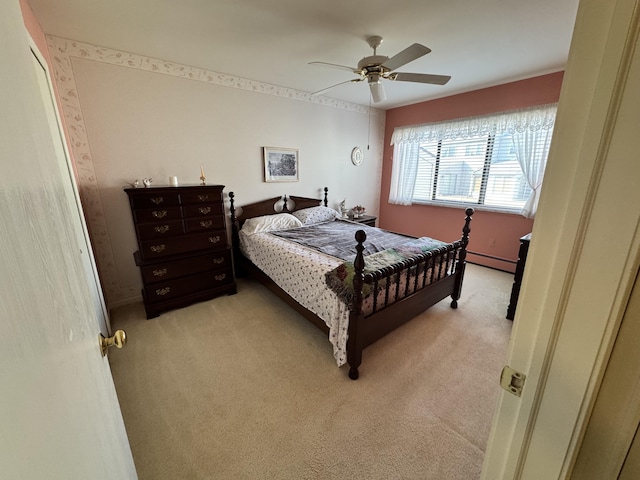 bedroom featuring a baseboard heating unit, light colored carpet, and ceiling fan