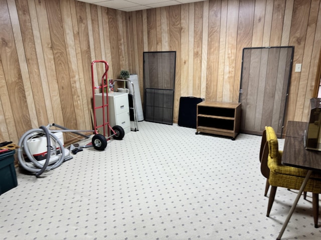 interior space featuring wooden walls and a paneled ceiling