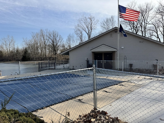 view of pool featuring a gate, a tennis court, and fence