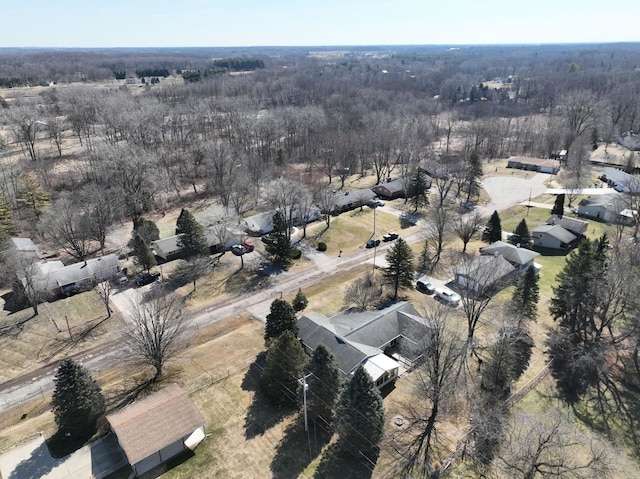 birds eye view of property with a view of trees