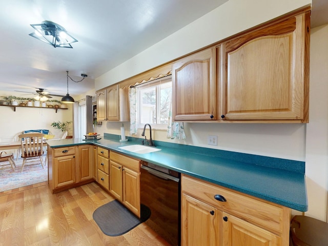 kitchen featuring dishwasher, light wood-style flooring, a peninsula, a ceiling fan, and a sink