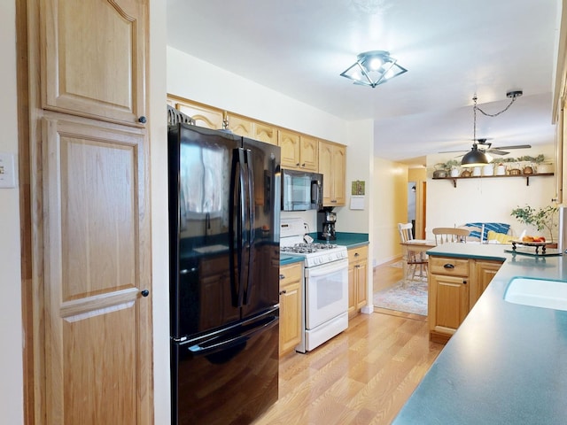 kitchen with light wood finished floors, light brown cabinets, ceiling fan, black appliances, and a sink