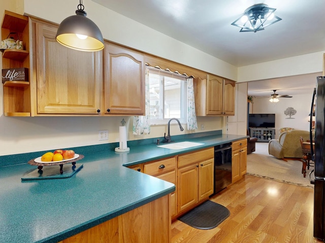 kitchen with a sink, open shelves, dark countertops, light wood-style floors, and dishwasher