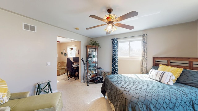 bedroom featuring light colored carpet, visible vents, and ceiling fan