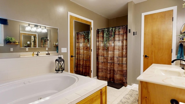 bathroom featuring a garden tub, vanity, and tile patterned flooring