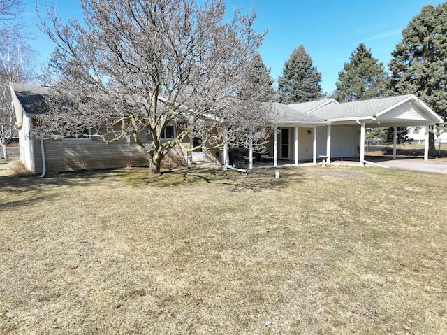 exterior space featuring an attached carport and a lawn