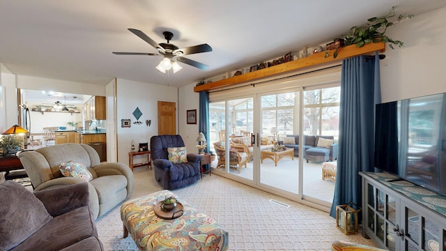 living room featuring light carpet, visible vents, and a ceiling fan