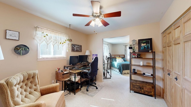 office featuring light carpet and ceiling fan