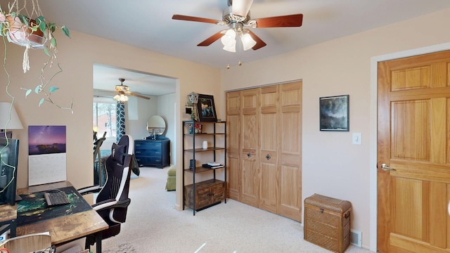 office featuring light carpet and ceiling fan