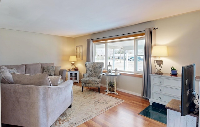 living area featuring wood finished floors and baseboards