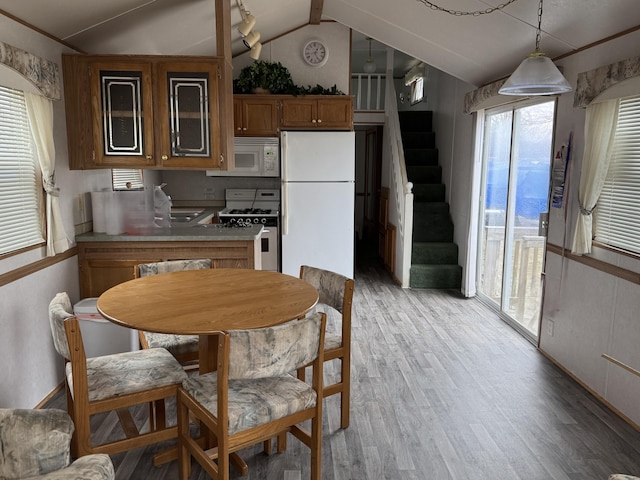 23040 Phillips St Lot 288, Edwardsburg, MI 49112 - kitchen featuring white appliances, vaulted ceiling, light wood-type flooring, a sink, and brown cabinets