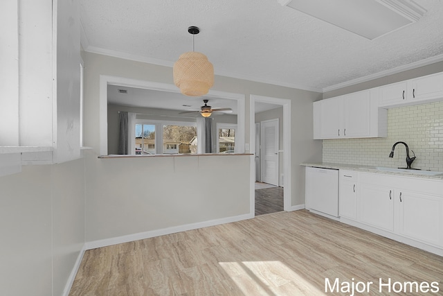 kitchen featuring light wood-style floors, white dishwasher, white cabinetry, a ceiling fan, and a sink