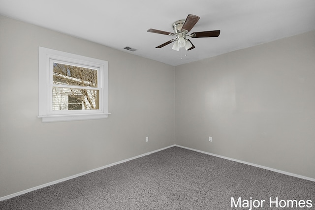 carpeted empty room featuring visible vents, baseboards, and ceiling fan