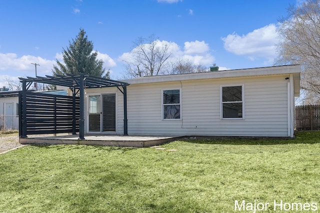 back of house with a yard, fence, and a pergola