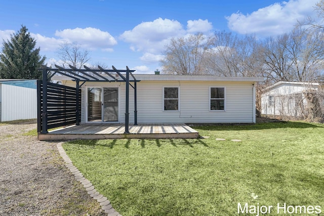 back of property featuring a yard, a pergola, and a wooden deck