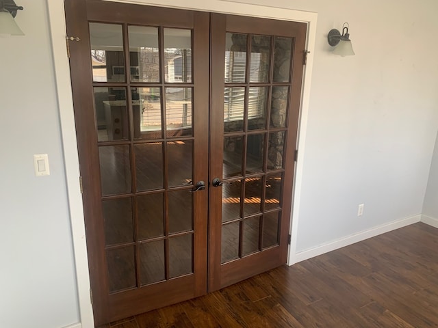 room details featuring french doors, baseboards, and wood finished floors